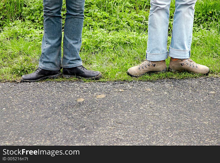 Two pairs of legs over tourist track, in funny pose. Free space below prepared for inscriptions. Two pairs of legs over tourist track, in funny pose. Free space below prepared for inscriptions.