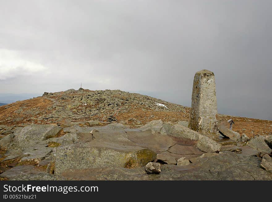 Peak of the rocky mountain in cloudy day, stone pillar. Peak of the rocky mountain in cloudy day, stone pillar.