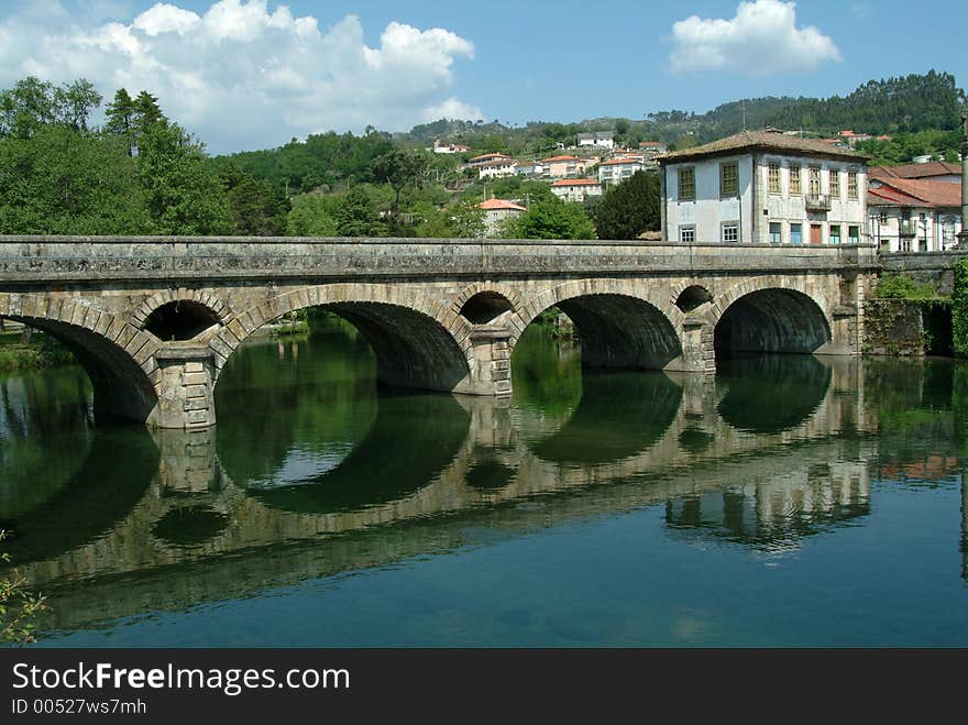 Roman bridge and river on village