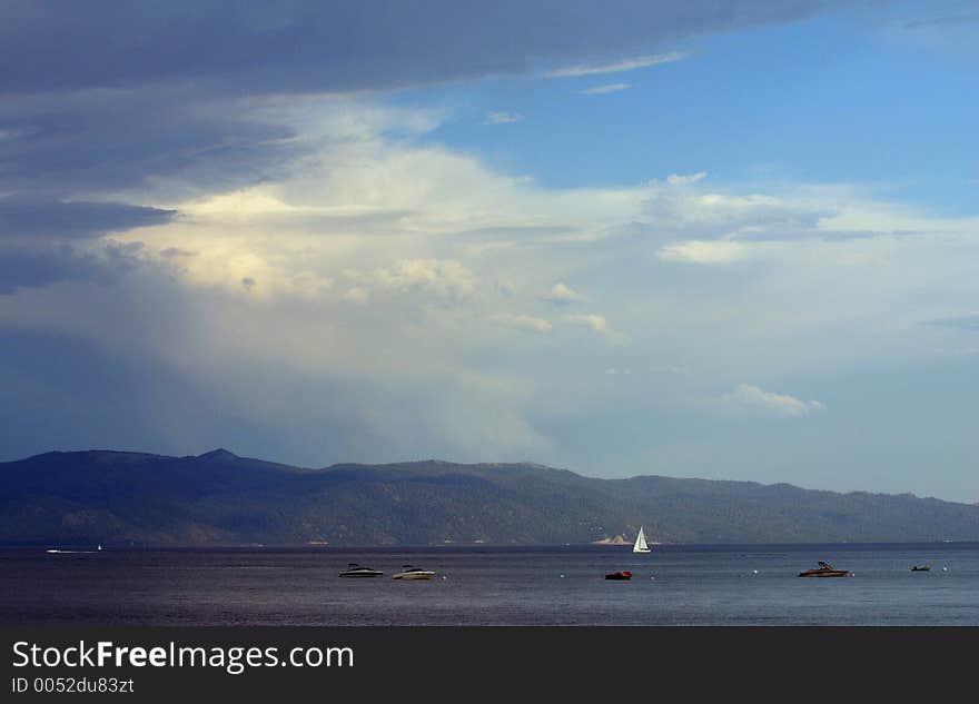 Lake filled with boats and a cloudy sky. Lake filled with boats and a cloudy sky.