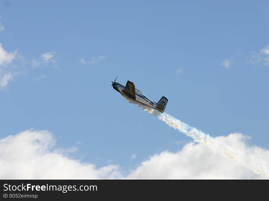 Plane flying through the clouds with smoke. Plane flying through the clouds with smoke.