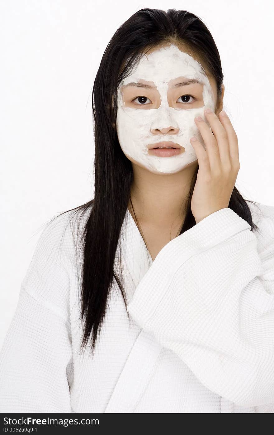 A young teen with a white face pack on