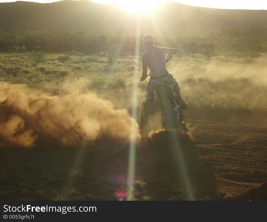 Man on a motorbike with sunset. Man on a motorbike with sunset