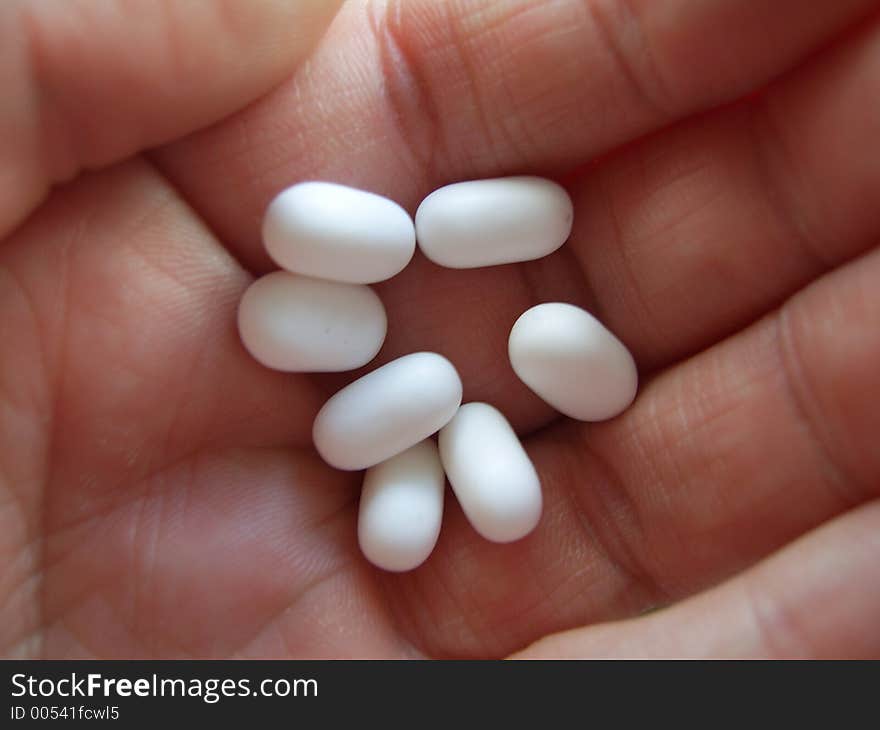 White pills in a hand. White pills in a hand