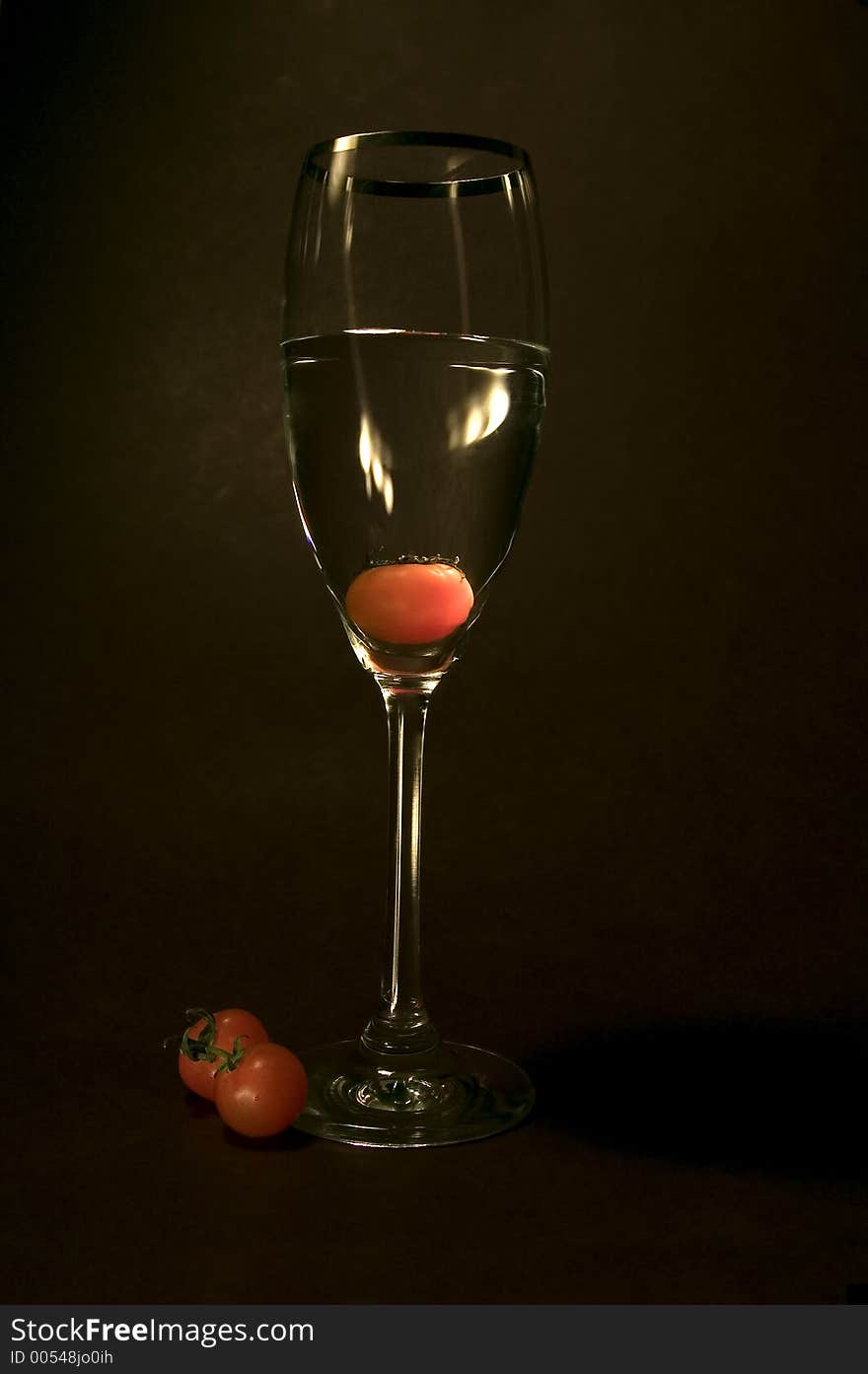 Tomato In The Glass In Black Background