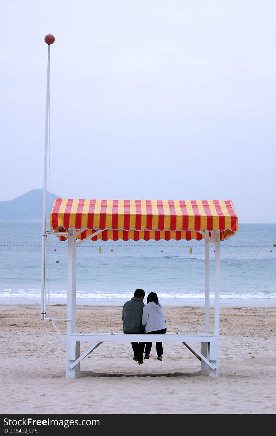 Love birds huddle at the sea. Love birds huddle at the sea