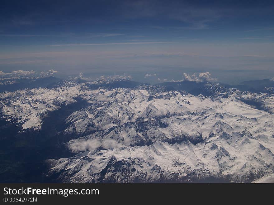 Windowseat view of the Alps mountains in Europe from 30.000 feet. Windowseat view of the Alps mountains in Europe from 30.000 feet.