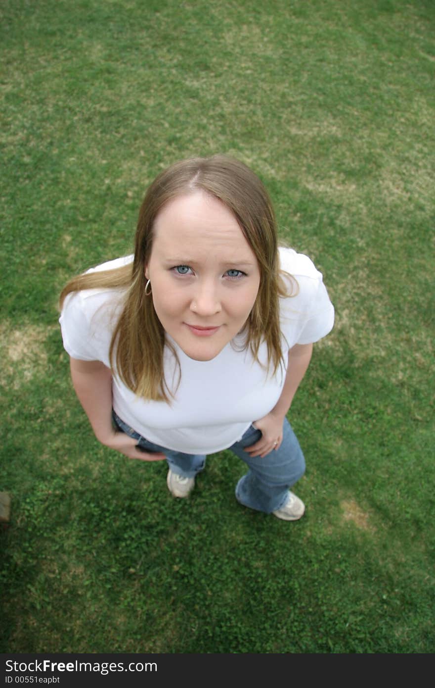 Young woman standing on grass. Young woman standing on grass