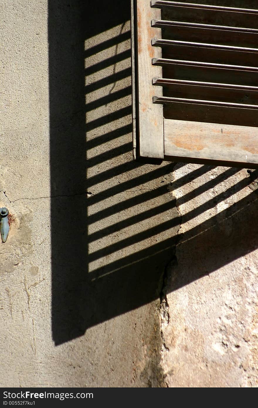 Corsica -France  in the summer: detail of shutter of an old house. Corsica -France  in the summer: detail of shutter of an old house