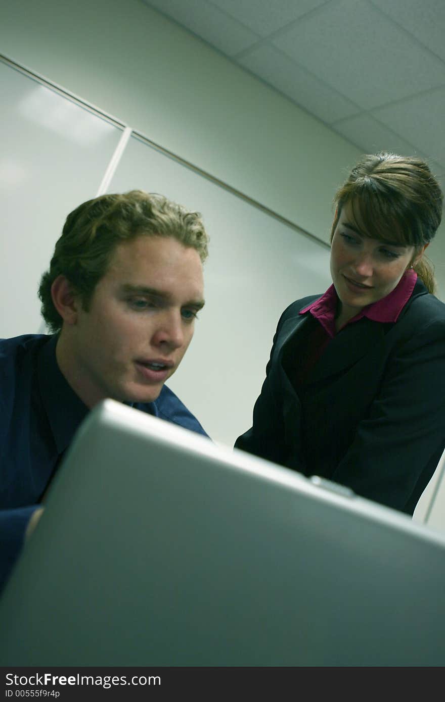 Man and women work on a project with a computer. Man and women work on a project with a computer