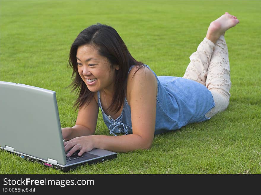 Lady using computer in a park. Lady using computer in a park