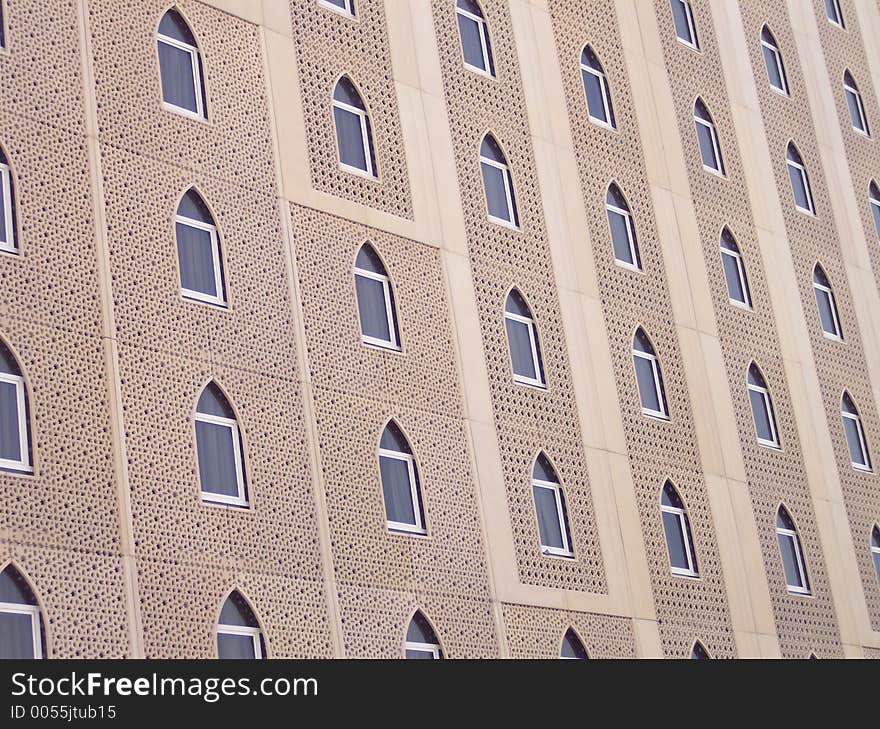 This is the outside of a building in Dubai. It shows some beautiful Arabian architecture. Dubai is in the United Arab Emirates.