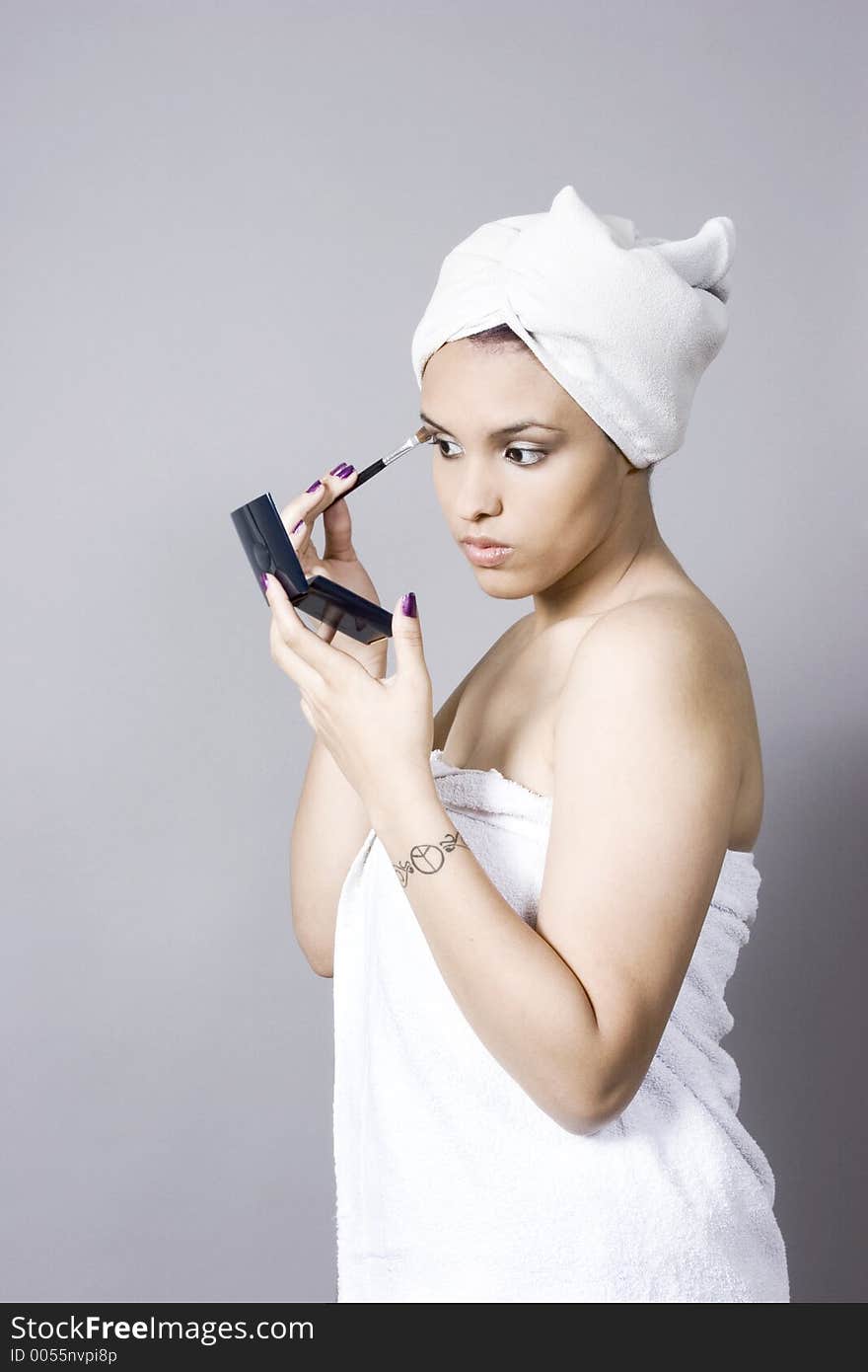 Attractive Young Woman Putting On Makeup