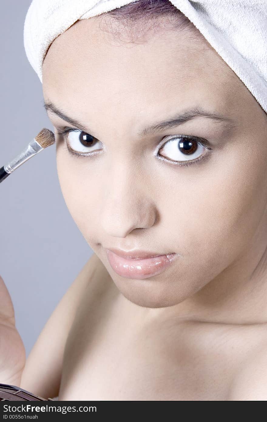 Attractive Young Woman Putting On Makeup