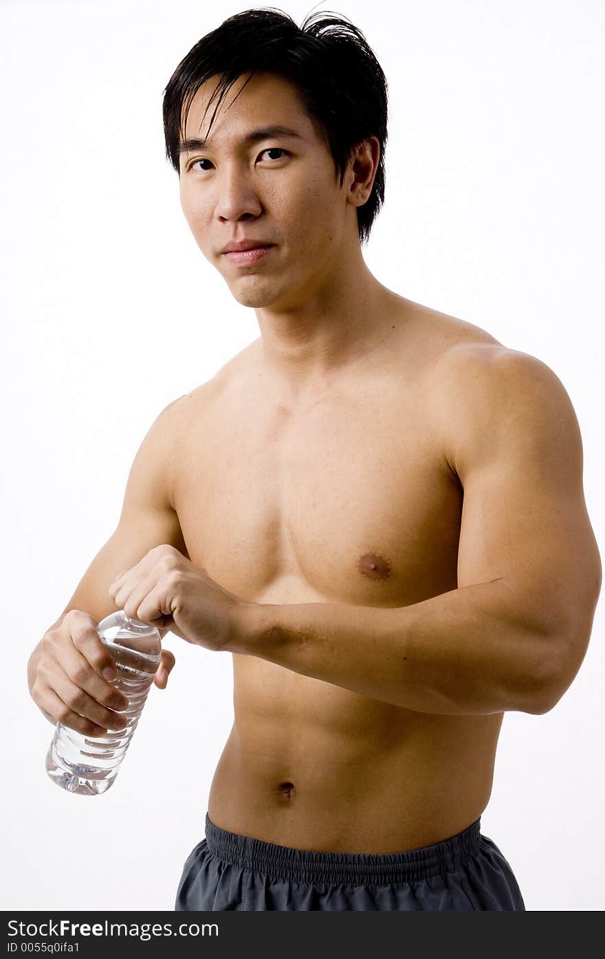 A well-built asian man holding a water bottle. A well-built asian man holding a water bottle