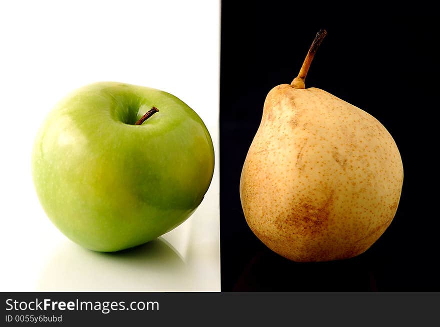 Big green ripe Granny Smith apple and yellow Chinese pear isolated on half white black background. Big green ripe Granny Smith apple and yellow Chinese pear isolated on half white black background