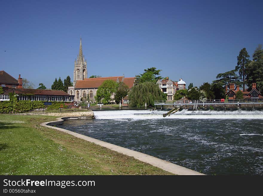 Scenic village on the river church in the background