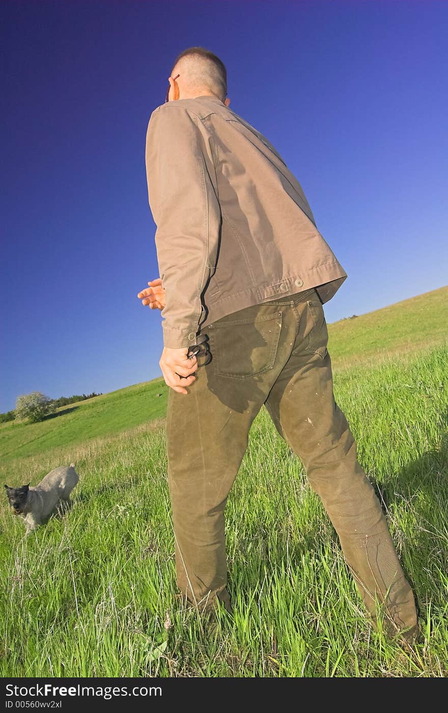 Man playing with dog on the meadow. Man playing with dog on the meadow