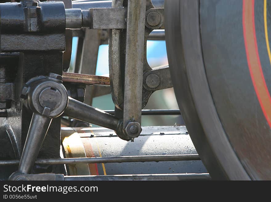 Detail shot of working traction engine showing part of the reversing gear, and the spinning (blurred) flywheel. Detail shot of working traction engine showing part of the reversing gear, and the spinning (blurred) flywheel.