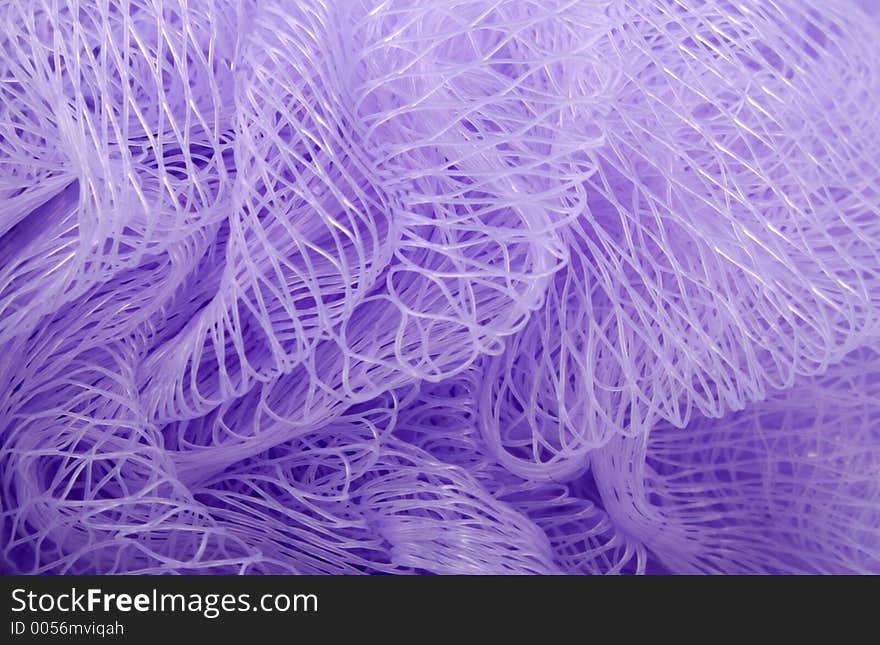 A close up of a mesh scrubber.  Can be used for a background. A close up of a mesh scrubber.  Can be used for a background