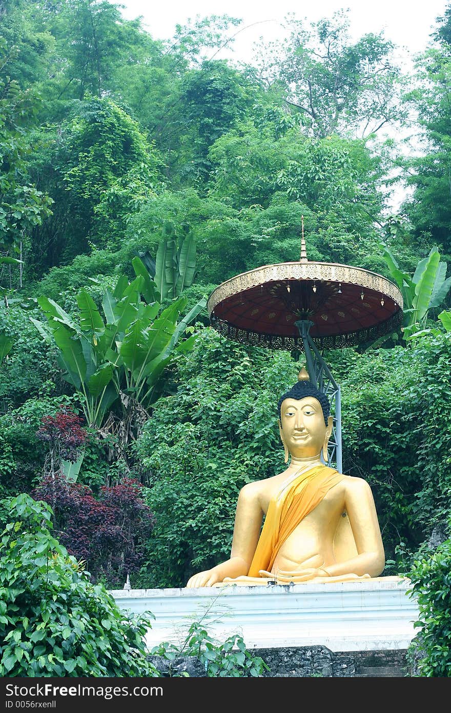 A giant Buddha by a hill, Thailand.