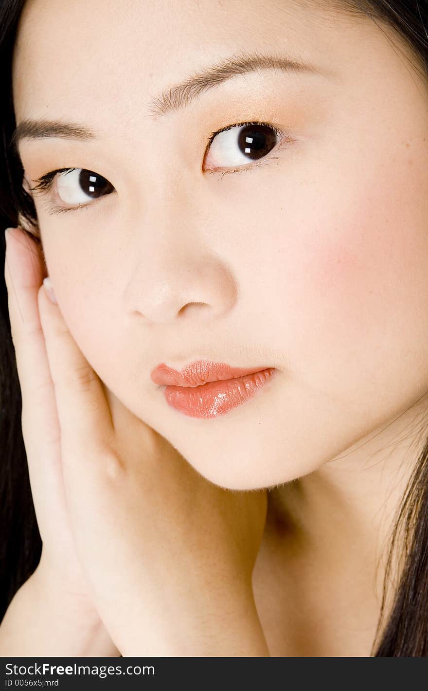 A beautiful young asian woman resting head on hands. A beautiful young asian woman resting head on hands