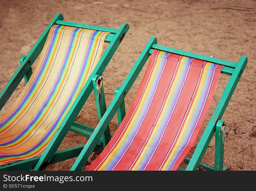 Striped and colorful - old faded deck chairs. Striped and colorful - old faded deck chairs