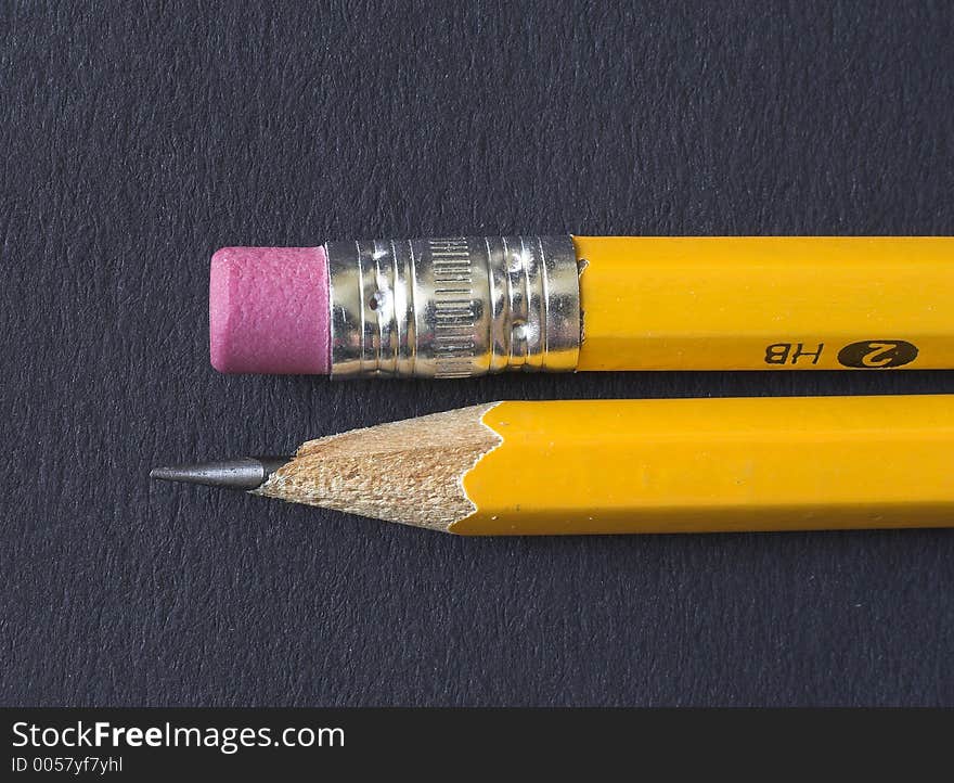 A pencil and an eraser on black background. A pencil and an eraser on black background