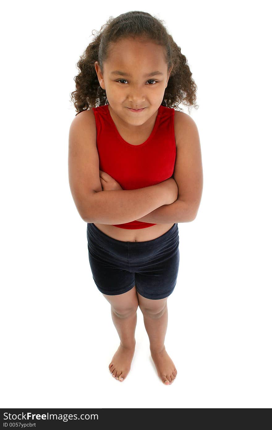 Seven year old girl in workout clothes standing with arms crossed. Seven year old girl in workout clothes standing with arms crossed.