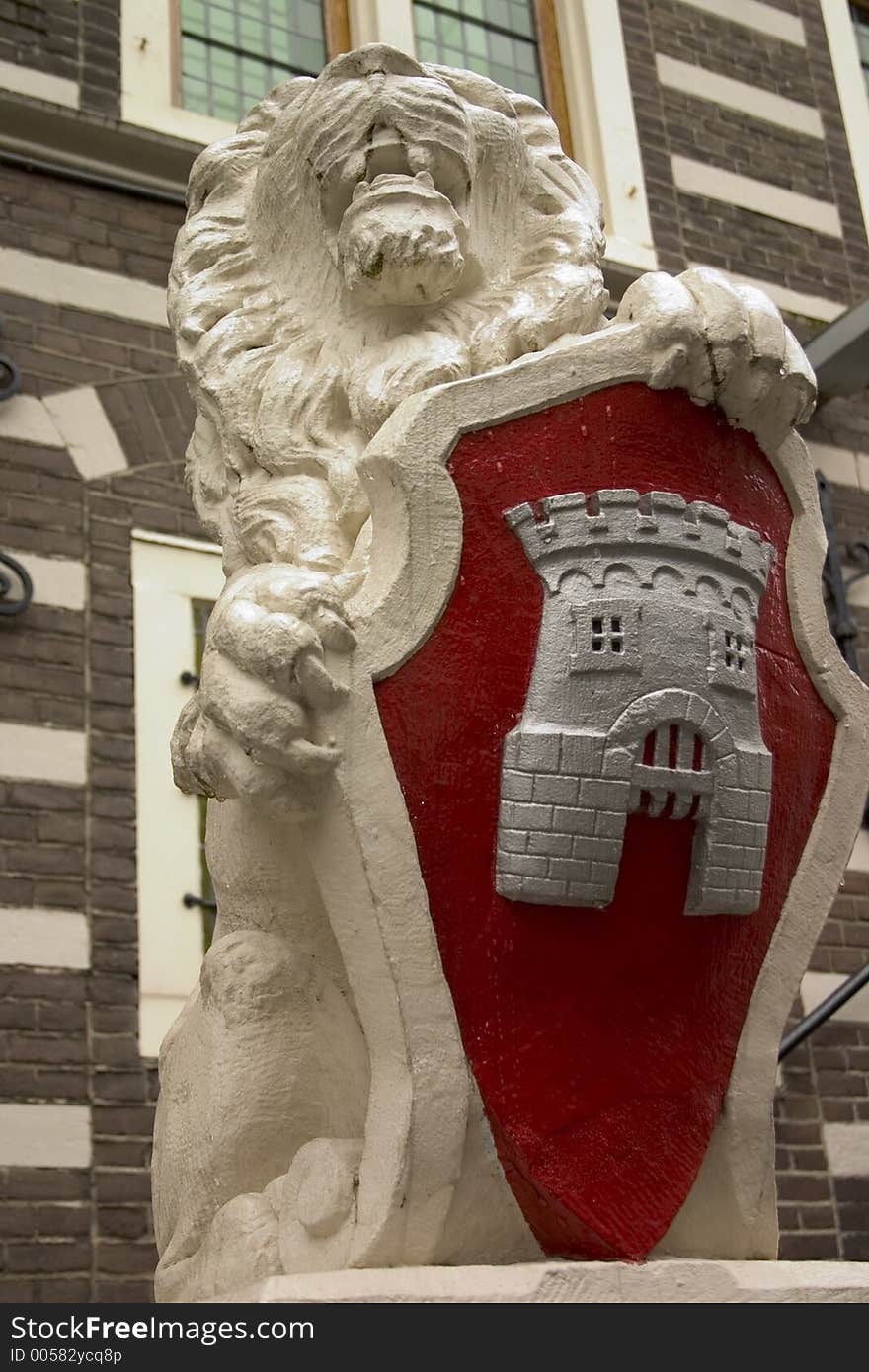 Statue of lion with bright red coat of arms. Statue of lion with bright red coat of arms