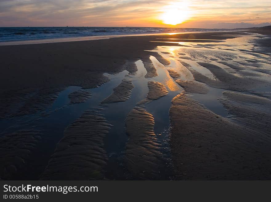 Sunset with warm colors of a mediterranean sea bech. Sunset with warm colors of a mediterranean sea bech