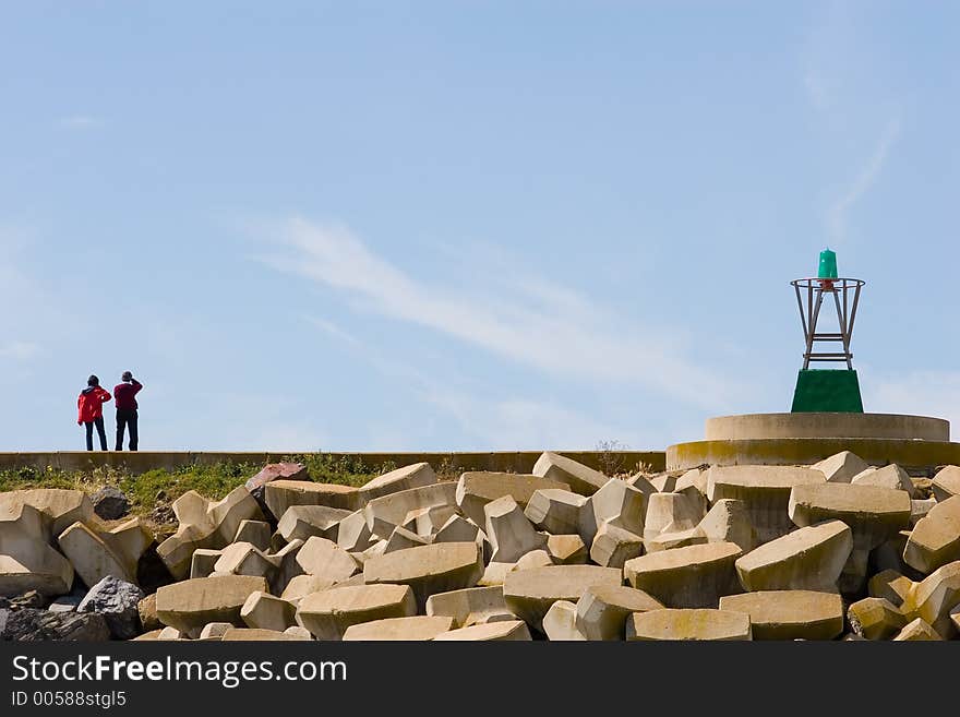 A couple looking at the sea in a dock