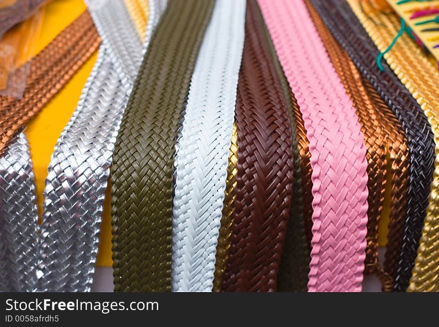 Lots of belts in a street market