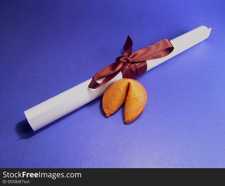 Fortune cookie and a graduation certificate. Fortune cookie and a graduation certificate