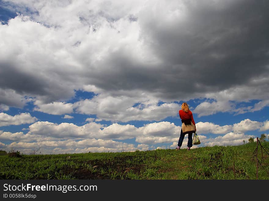 Woman, road and clouds. Sibir.