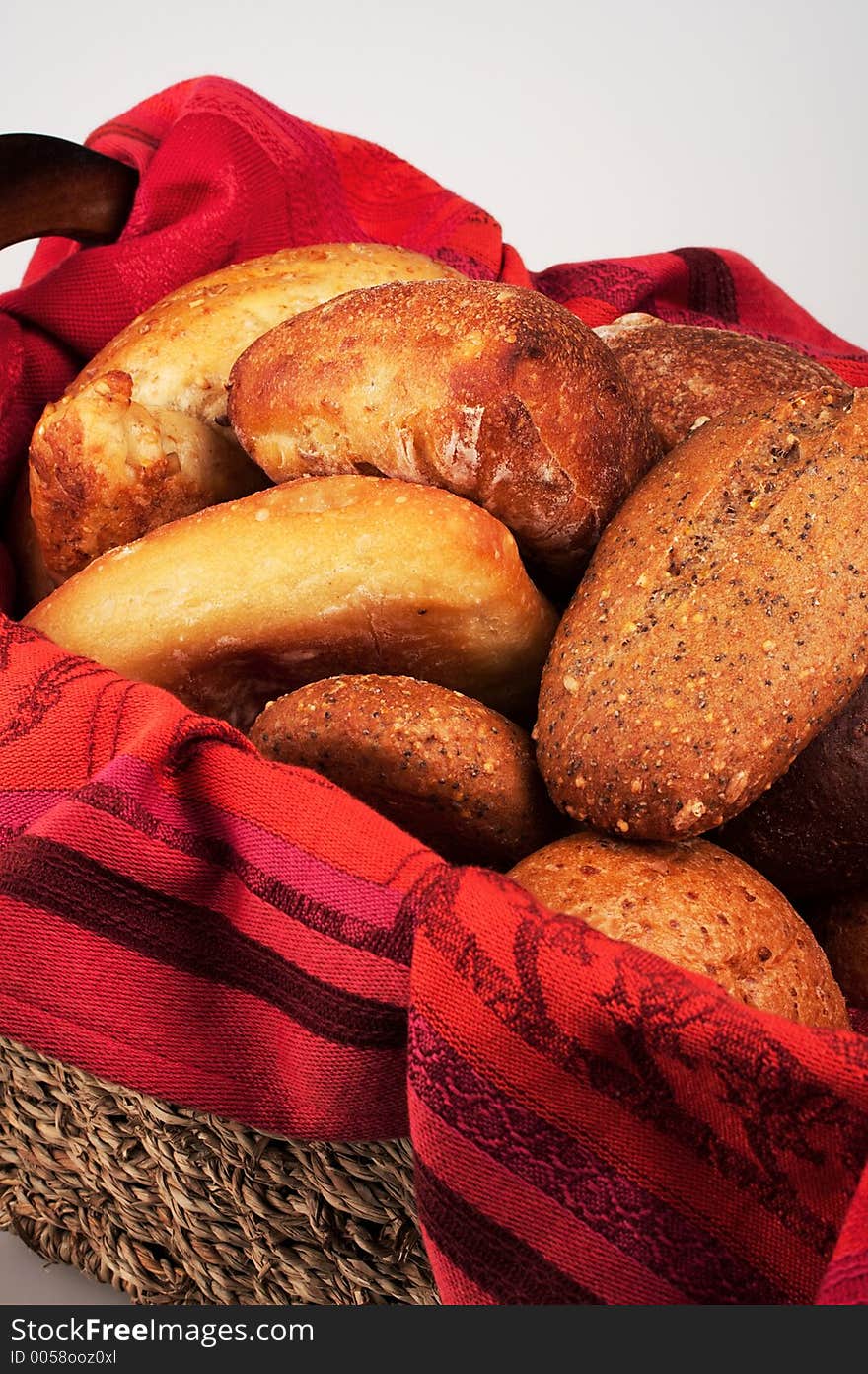 An elegant setting of dinner breads in a woven basket lined with a luxuriously red cloth. An elegant setting of dinner breads in a woven basket lined with a luxuriously red cloth.