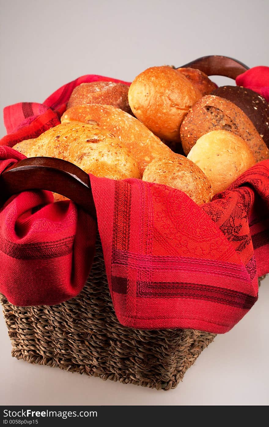 An elegant setting of dinner breads in a woven basket lined with a luxuriously red cloth. An elegant setting of dinner breads in a woven basket lined with a luxuriously red cloth.