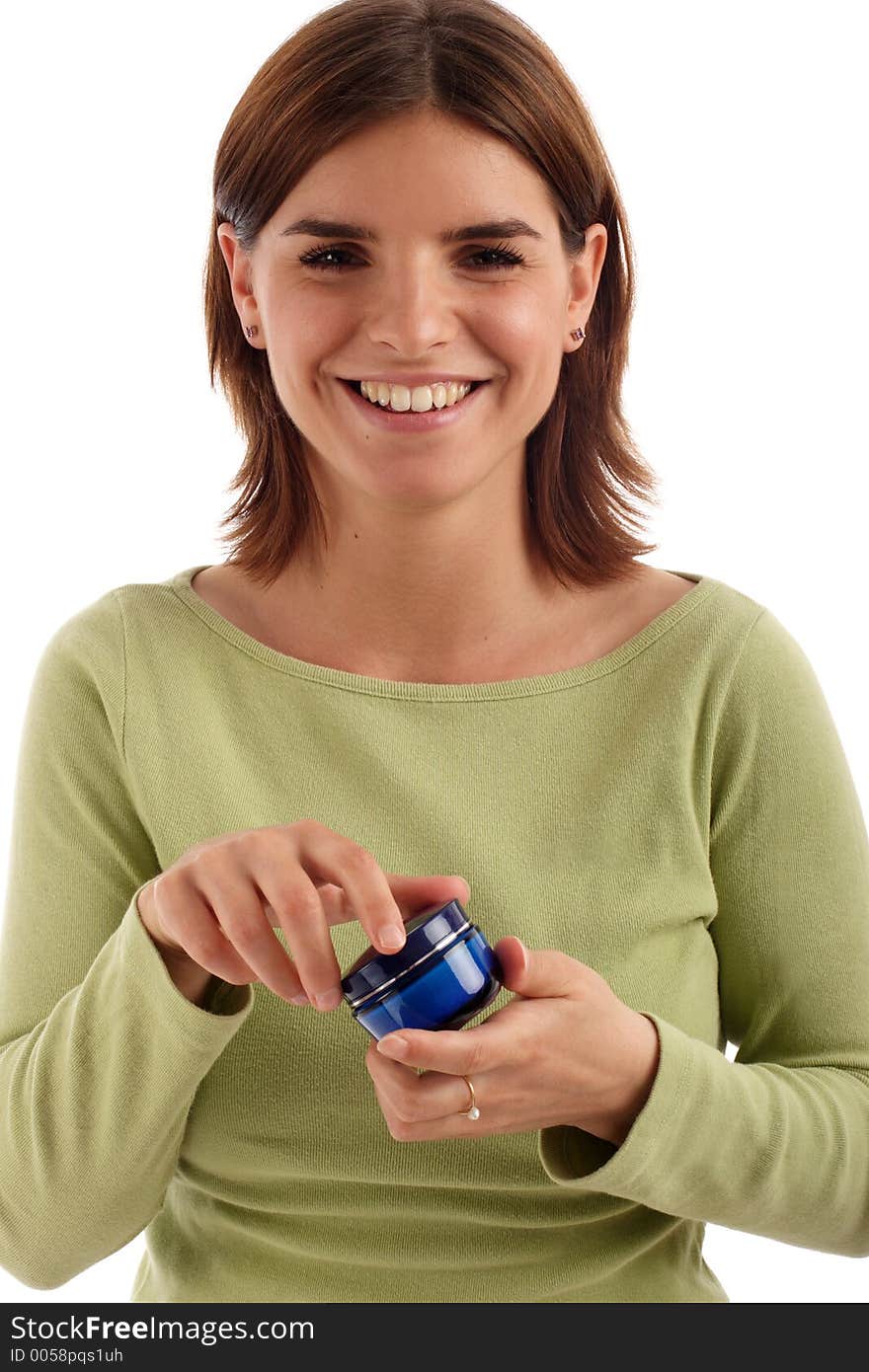 Pretty young woman holding facial cream. Pretty young woman holding facial cream