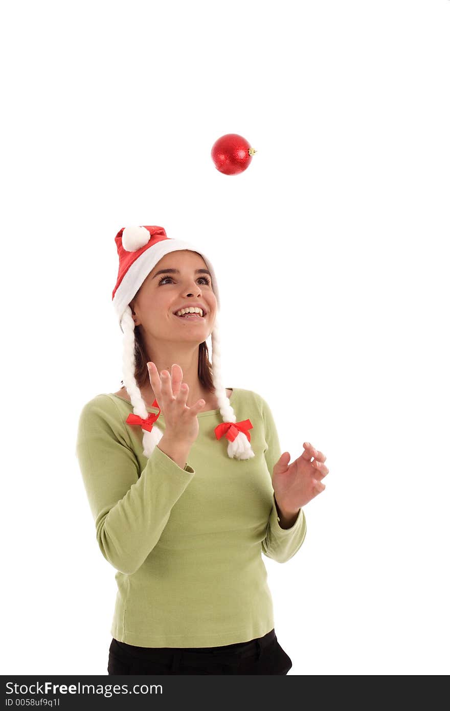 Stock photo of a young woman playing with Christmas ornament (red bauble)