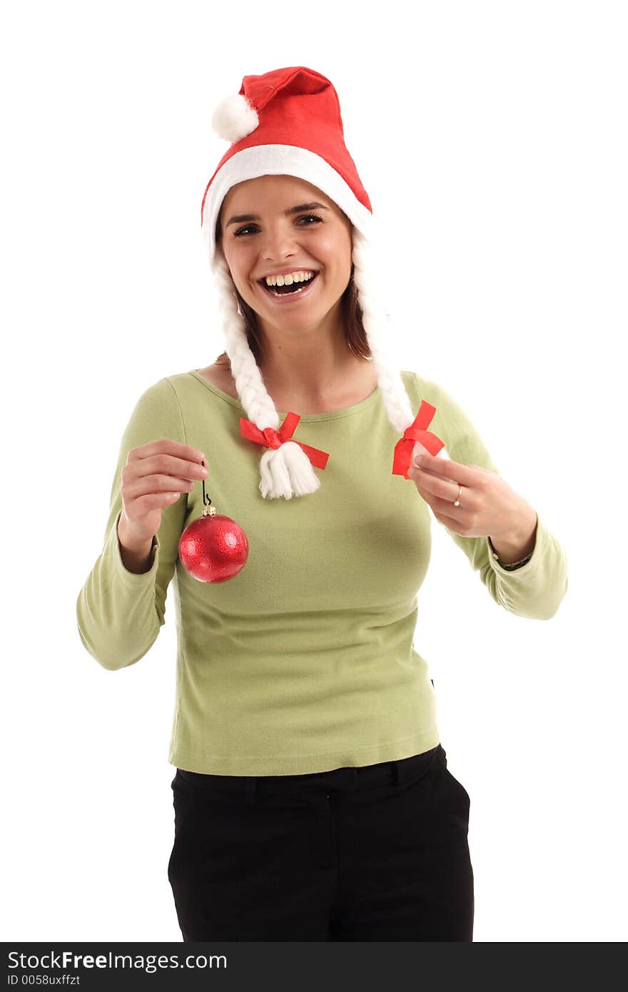 Portrait of a young pretty woman wearing Santa hat, holding red Christmas tree ornament. Portrait of a young pretty woman wearing Santa hat, holding red Christmas tree ornament