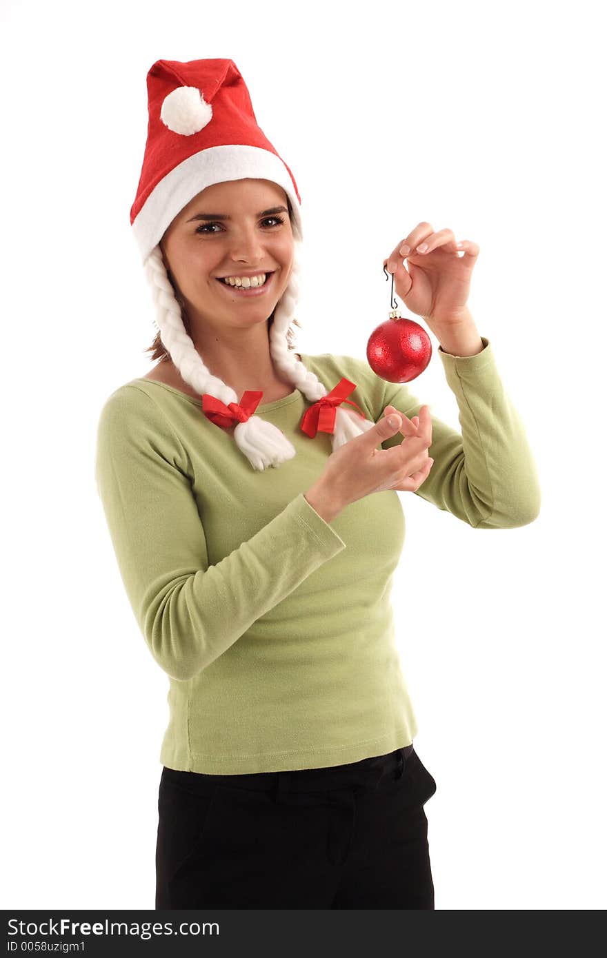 Portrait of a young pretty woman wearing Santa hat, holding red Christmas tree ornament. Portrait of a young pretty woman wearing Santa hat, holding red Christmas tree ornament