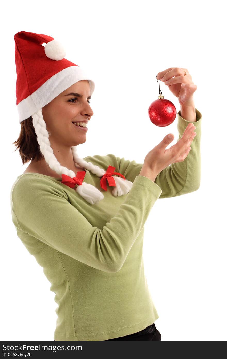 Portrait of a young pretty woman wearing Santa hat, holding red bauble. Portrait of a young pretty woman wearing Santa hat, holding red bauble