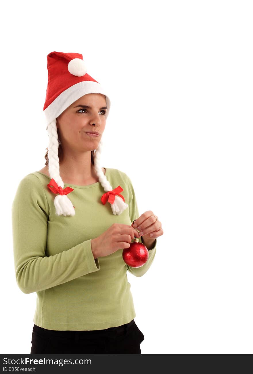 Portrait of a young pretty woman wearing Santa hat, holding red Christmas tree ornament. Portrait of a young pretty woman wearing Santa hat, holding red Christmas tree ornament