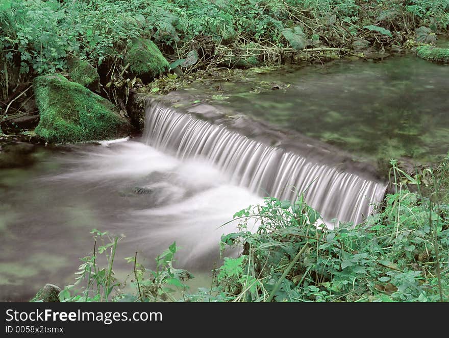 Silent spruit with waterfalls in beautiful environs. Silent spruit with waterfalls in beautiful environs.