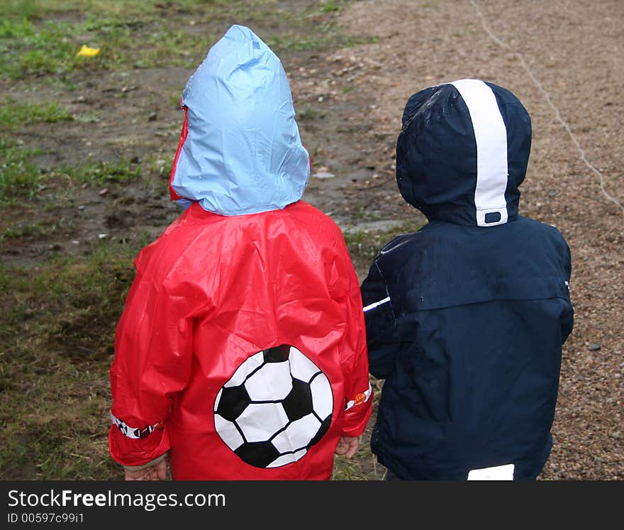 Young football fans in rainy day