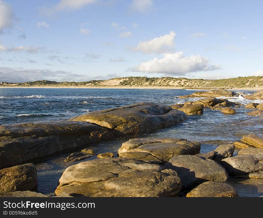 A secluded granite strewn beach. A secluded granite strewn beach