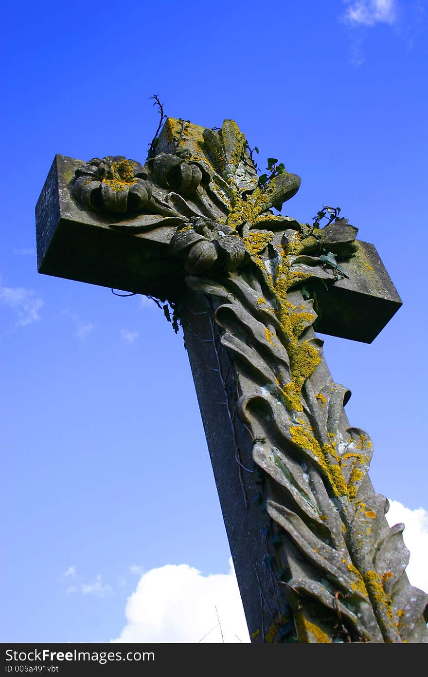 Shot looking up at a stone crucifix against a blue sky for use as a Christian symbol especially at Easter time. Shot looking up at a stone crucifix against a blue sky for use as a Christian symbol especially at Easter time.