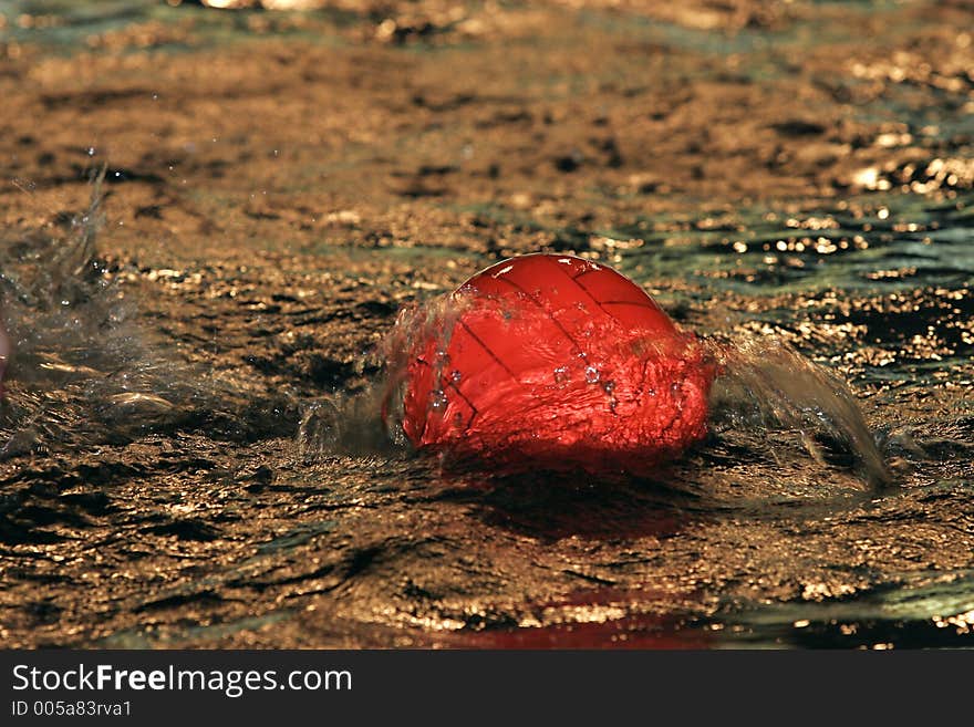 The image of a red ball on water. The image of a red ball on water