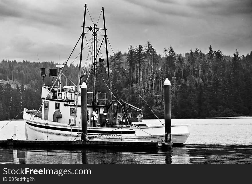 A fishing boat docked in harbor. A fishing boat docked in harbor