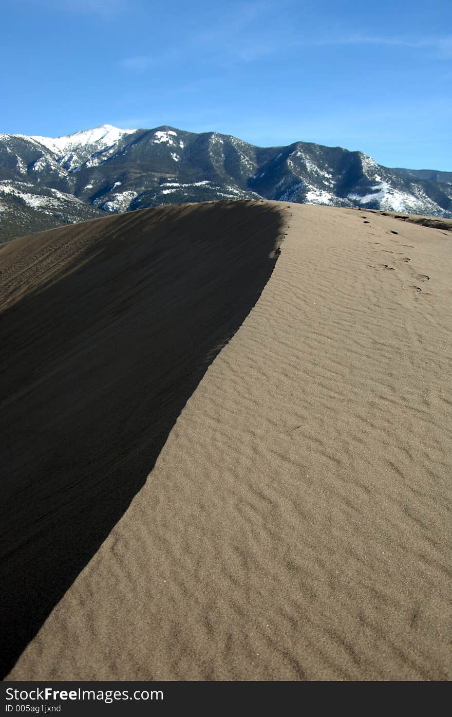 Great Sand Dunes during afternoon sun, casting a shadow. Great Sand Dunes during afternoon sun, casting a shadow